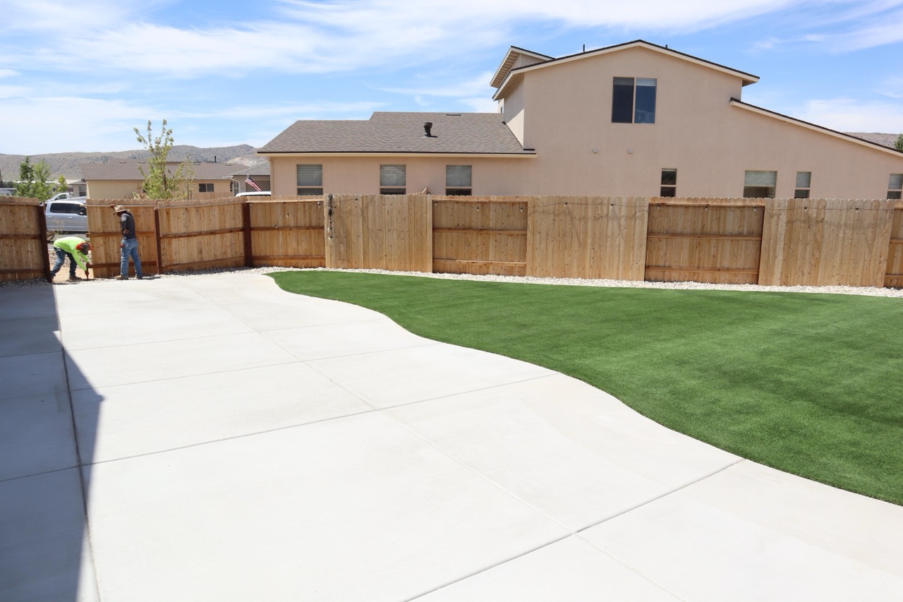 Longhorn Landscaping crew finishing a backyard cleanup and lawn install